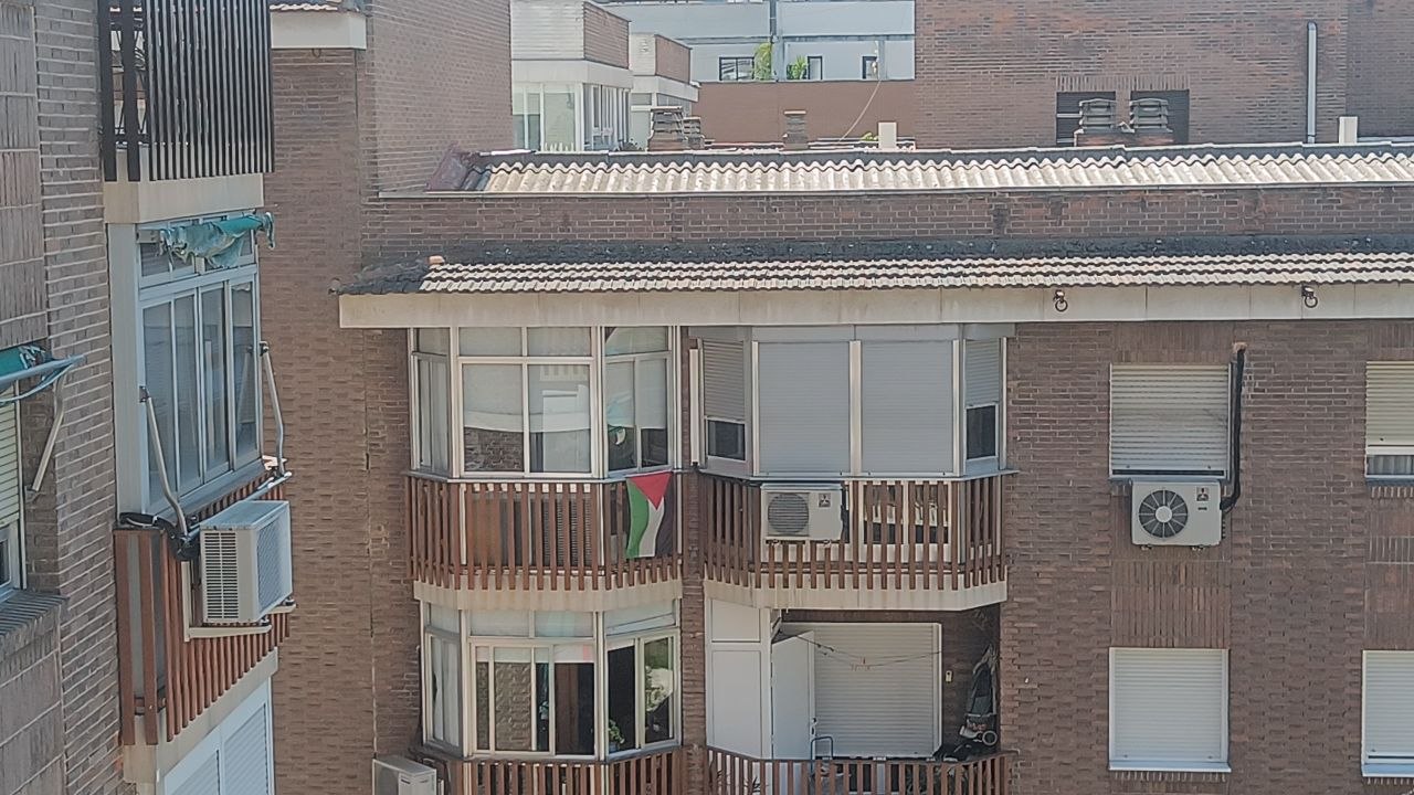 Balcón de Moratalaz con bandera palestina colgada entre dos aires acondicionados